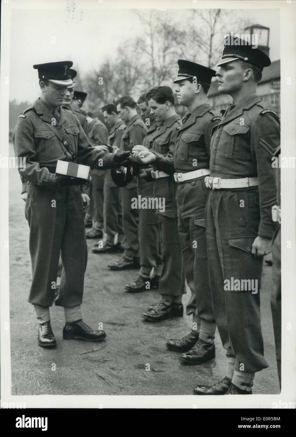 Mar. 01, 1958 - ST. DAVID'S DAY CELEBRATIONS: The 1st.Battalion Welsh Guards today celebrated St. David's Day at Pirbright Camp, Brookwood, Surrey. Major General J.I.R.Moore, CB, CBE., DSO, General Officer Commanding Household Brigade, presented leeks to the Battalion on a parade. Keystone Photo Shows:- Major P.de Zulueta, Commander of No.2 Company, hands out leeks at Pirbright camp today. Stock Photo