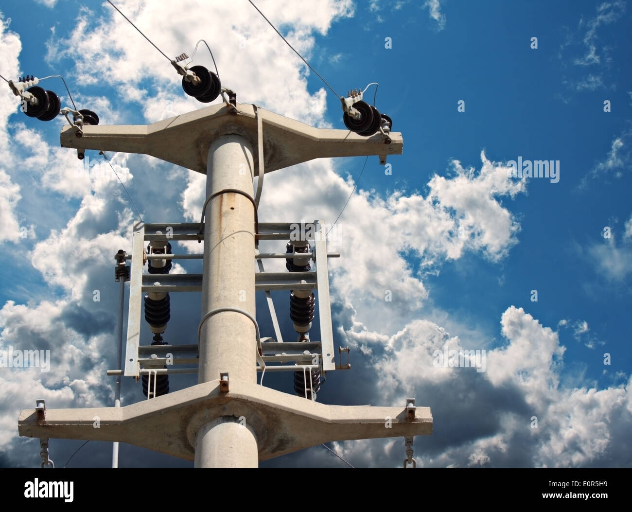 Electricity pylon against a blue sky with clouds Stock Photo - Alamy