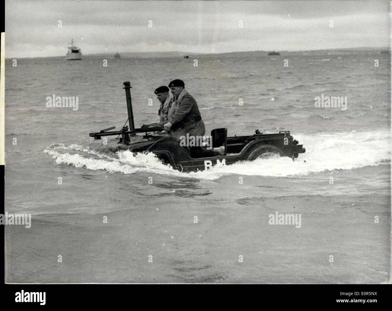 May 19, 1958 - Exercise ''Run Aground XI'' - at Southsea: Exercise ''Run Aground XI'' - was carried out on the Eastney Beach, Southsea, today - in which staff College Students saw some of the craft - methods and equipment used in amphibious operations. The exercise included an assault by Royal Marine Troops mounted from a Commando Carrier - in helicopters. Photo Shows A Land Rover almost covered by water during the exercises on Eastney Beach this afternoon. Stock Photo