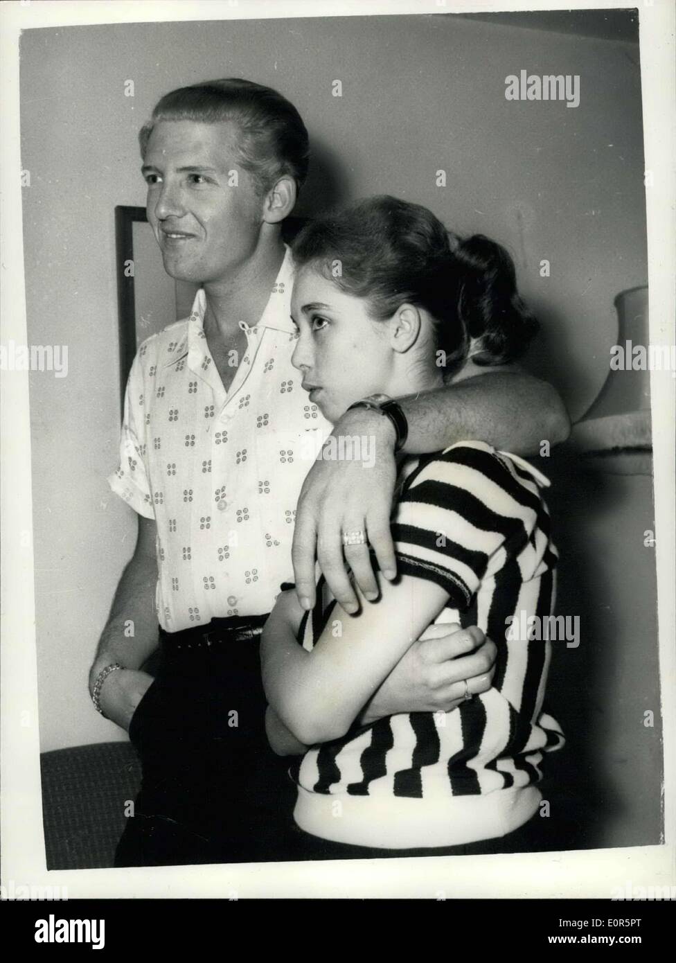 May 23, 1958 - 22 Year-Old American Rock 'N Roll Singer Arrives Here With His 15 Year Old Wife; Jerry Lee Lewis, the American rock ' n roll singer, flew into London yesterday with a shock for his fans. For the girl who arrived with him turned out to be his 15 year old wife of two months. her name was Myra, and she is his third wife. Jerry was first married at 15 and again at 17, but this time he says he has found the right girl. When asked if she thought that fifteen was too young to be a wife, Myra explained that back at her home town Memphis Tennessee, you can marry at the age of ten Stock Photo