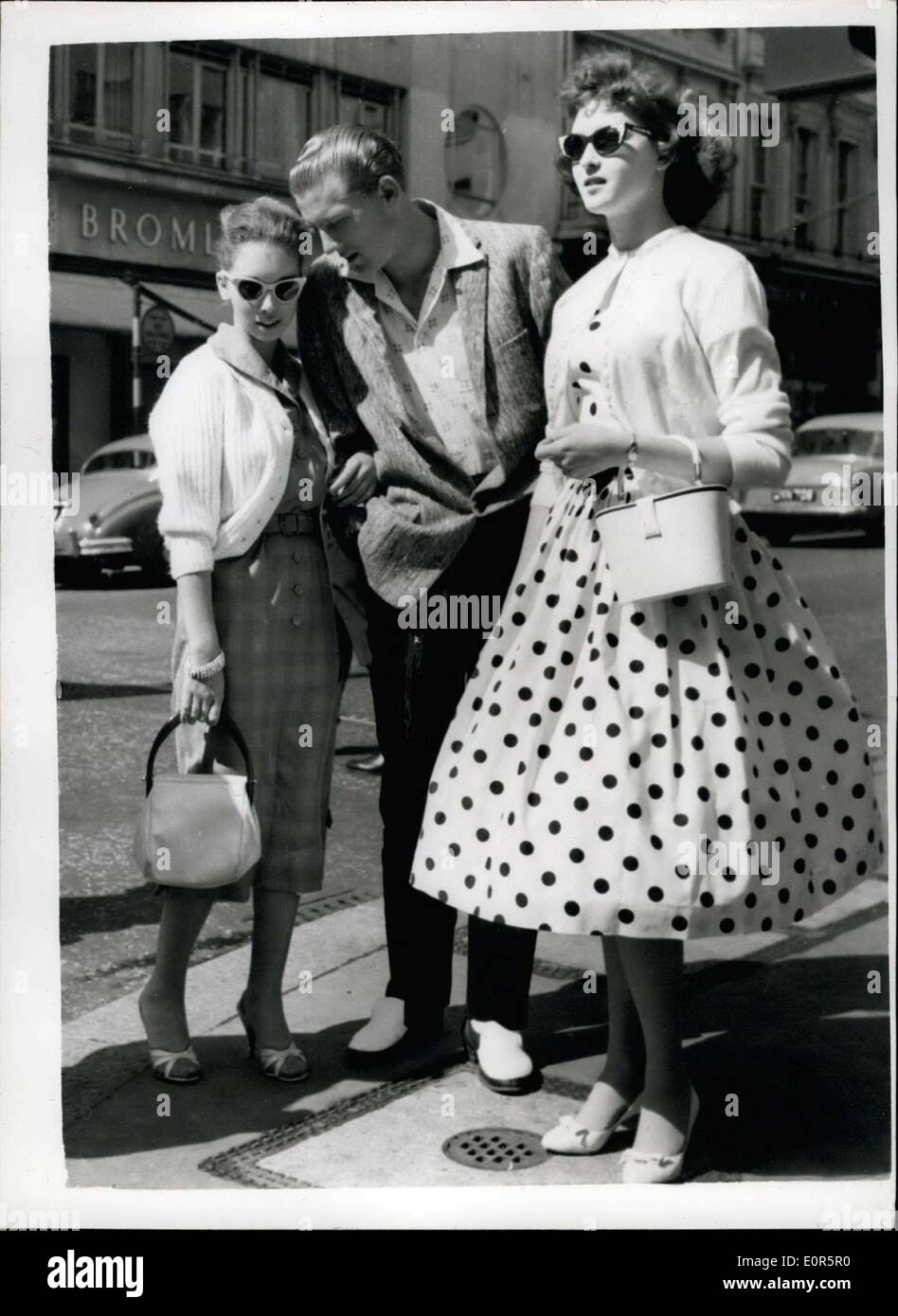 May 24, 1958 - JERRY LEE LEWIS TAKES HIS 15-YEAR OLD WIFE OUT IN LONDON. Photo Shows:- The American rock ?n Roll singer, Jerry Lee Lewis, 22, pictured in London?s West End yesterday with his 15-year old wife, Myra (left), and his 15-year old sister, Frankie. Myra is his third wife. Stock Photo