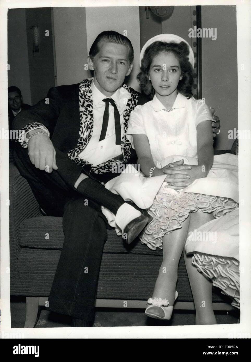 May 26, 1958 - HOME OFFICE TO INVESTIGATE MARRIAGE OF JERRY LEE LEWIS. The Home Office is tomorrow to investigate the marriage muddle of the 22-year old America Rock n' Roll singer, Jerry Lee Lewis, who is here on a tour and his 13-year old wife, Myra. Lewis and Myra are staying in London. During the week-end it was discovered that their marriage last December was five months before his divorce from his second wife became final. Myra's father, Mr. J.W. Brown, his wife, Lois and his son, are staying at the same hotel, in London Stock Photo