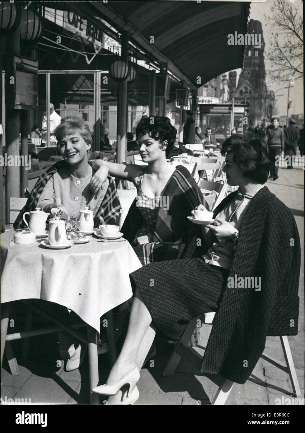 Apr. 04, 1958 - Fresh Air on the Ku'dammm: Then sun is shining in Berlin. But still it is a little too old to sit in the open air and who by all means wants to show the new springtime dress, sometimes has to cover it with a blanket. From left to right side: the starlets Sabina Sesselmann (Sabina Sesselmann), Renate Ewert (Renate Ewert) and Regina Petrowa (Regina Petrowa) during a rehearsal of the film ''Love may be like posion' Stock Photo