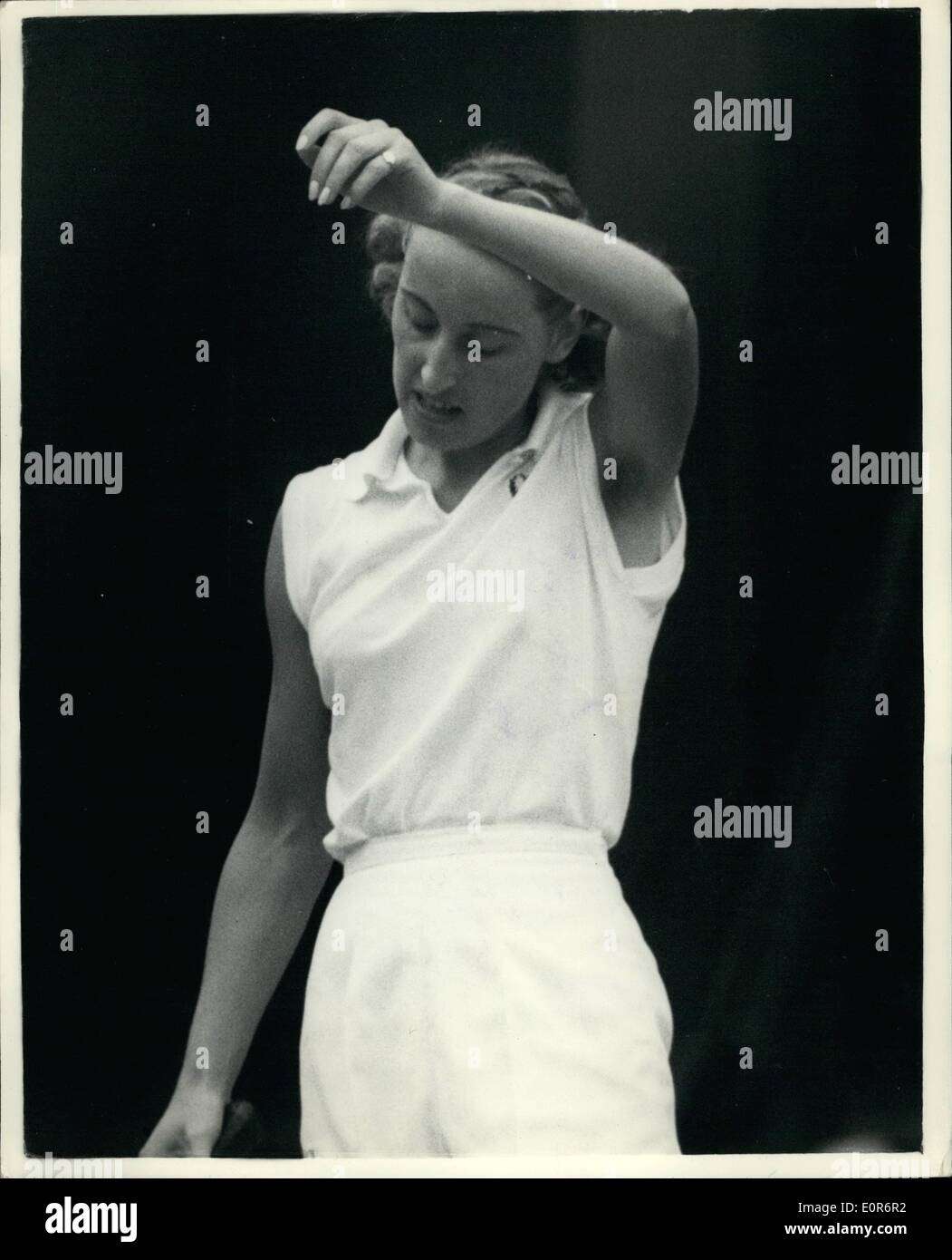 Jun. 06, 1958 - Wimbeldon Tennis Championships Miss Mortimer Wins Her Match Miss A. Mortimer (GB) wipes the presperation off ehr forehead-during her match with Miss E. Buding (Stateless-originally from Germany)- in the ladies' singles at Wimbledon this afternoon.. Miss Mortimer won 6-2;6-4. Stock Photo