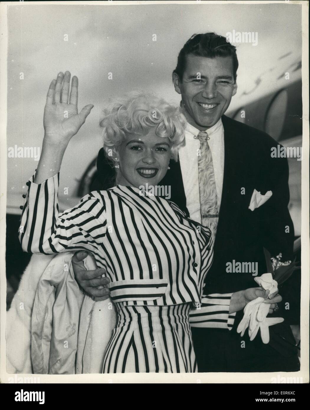May 05, 1958 - Jayne Mansfield and Husband Fly To Caines Film Festival.: Popular screen star Jayne Mansfield and her husband Micky Hargitay - left London Airport this morning - for the Cannes Film Festival. Photo shows Jayne Mansfield and husband at London Airport this afternoon. Stock Photo