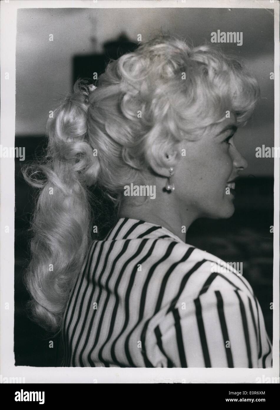 May 05, 1958 - Jayne Mansfield and Husband Fly to Cannes film Festival: Leaving London by air today was American film star Jayne Mansfield who is flying to Cannes to attend the film festival. She was accompanied by her husband Micky Hapgitay. Photo shows Jayne Mansfield - with her ''Horsey'' hair style - as she left London airport this morning. Stock Photo