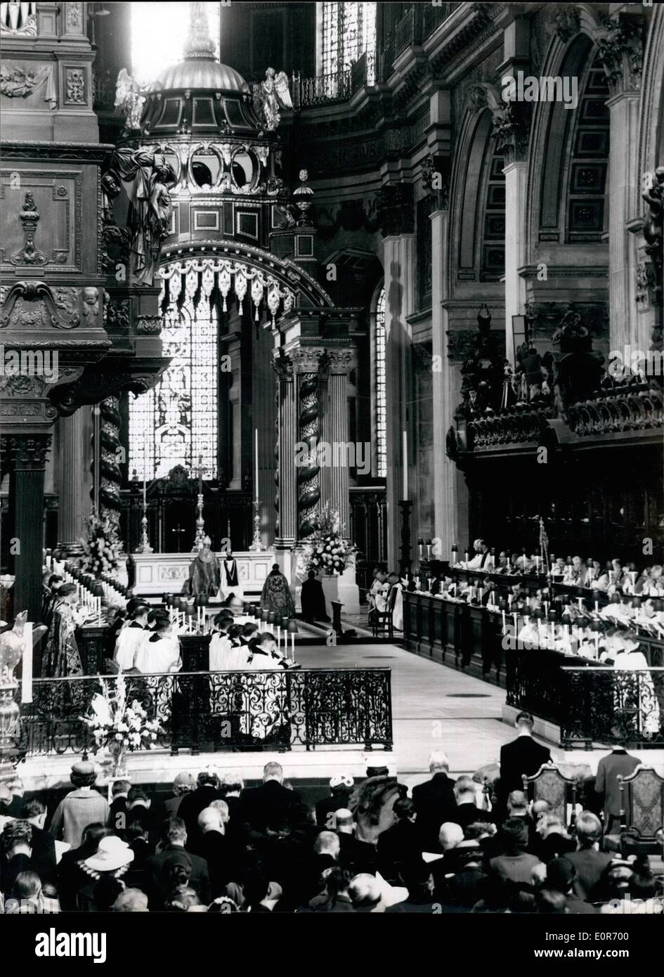 May 05, 1958 - Queen attends dedication at ST .Paul's. The Queen and the Duke of Edinburgh today attended a service for the re-dedication of the restored caster Bart of St. Paul's Cathedral and the dedication of the new High Altar as a memorial to the 35,451 men and women of the Commonwealth overseas who died in the two world wars. Photo shoes the  in the Cathedral during the blessing by the Archbishop of sanzerbury showing the Queen and the Duke of Edinburgh seated at prayer. Stock Photo