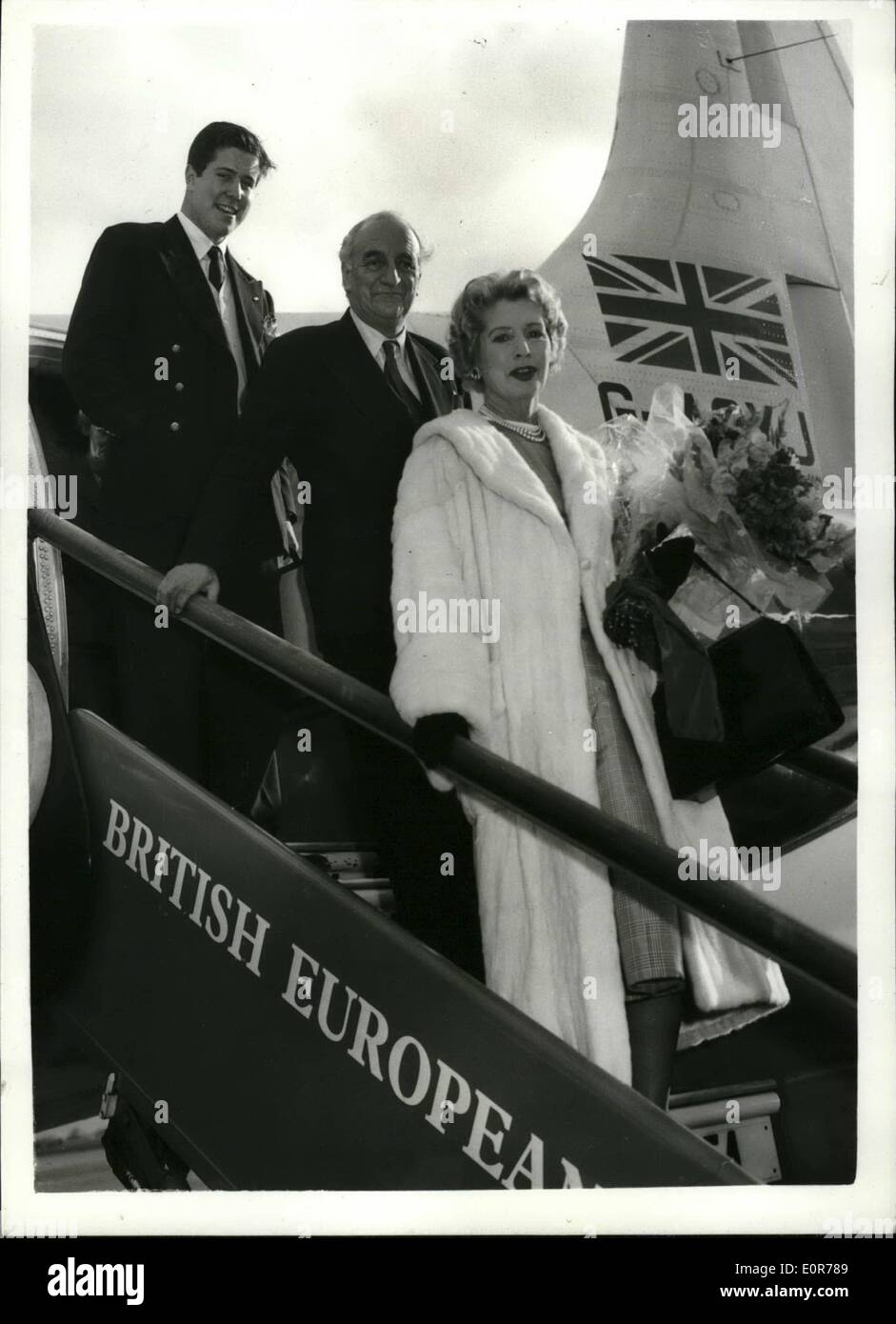 May 05, 1958 - The Dockers Arrive Home From Riviera: Sir Bernard and Lady Docker and the latter's son Alance arrived at London Airport this evening from the French Riviera.. The Dockers have been expelled from the Monaco and Alpes-Maritime Province of France which includes Cannes and Nice following an incident in which Lady Docker is alleged to have destroyed a Monegasque flag. Photo shows Sir Bernard and Lady Docker followed by Lance, leaving the aircraft on arrival at London Airport this evening. Stock Photo