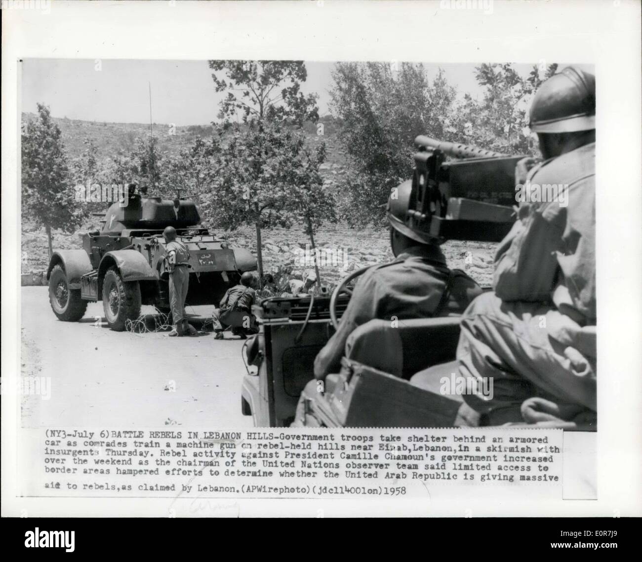 Jul. 06, 1958 - Battle Rebels In Lebanon Hills - Government troops take shelter behind an armored car as comrades train a machine gun on rebel - held hills near Einab, Lebanon, in a skirmish with insurgents Thursday. Rebel activity against President Camille Chamoun's government increased over the weekend as the chairman of the United Nations observer team said limited access to border areas hampered efforts to determine whether the United Arab Republic is giving massive aid to rebels, as claimed by Lebanon. Stock Photo