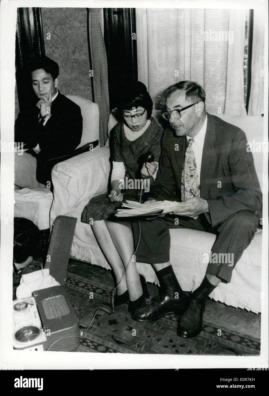 May 05, 1958 - American Attorney Interviewing Hiroshima ''A'' Bomb Victim. He Files Anti Nuclear Bomb Suit Against U.S. Government.: Dr. Abraham Lincoln Wirin (right) interviews Japanese girl Michiko Saka (25) IN Tokyo - where Dr. Wirin - an American Attorney - is collecting materials to support his case - for he has filed an anti- nuclear bomb test suit against the United States Government . Michiko Saka was a victim of the Hiroshima bomb - and recently visited the U.S. for plastic surgery on her face - to repair damaged cause by the bomb. Dr Stock Photo