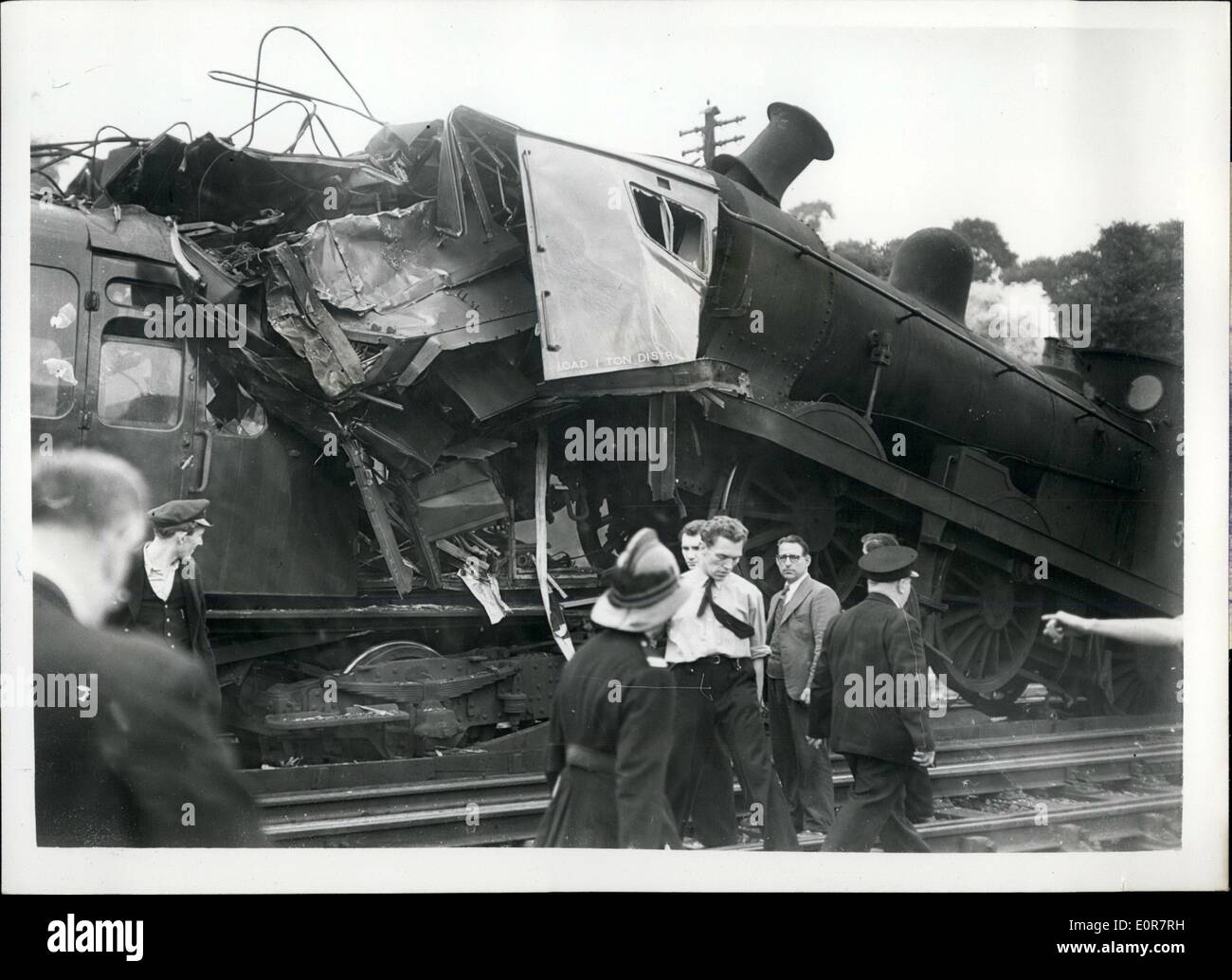 Jul. 07, 1958 - Many Injured In London Train Crash: Between twenty and thirty people have been injured this morning in a collision between a steam train and an electric train at Maze Hill railway station, Greenwich. Photo shows The engine of the steam train perched on top of the smashed electric train - at Maze Hill today. Stock Photo