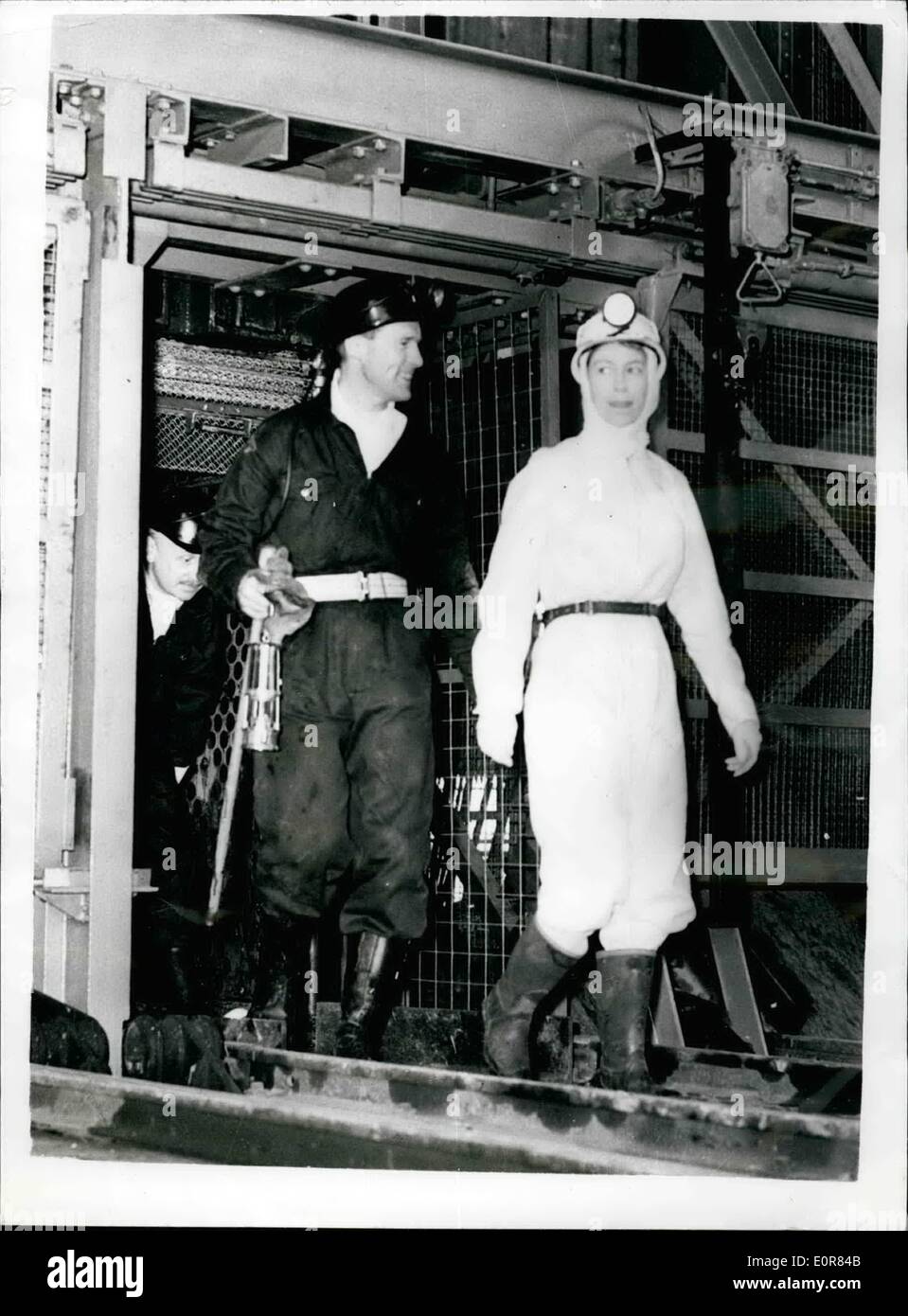 Jul. 07, 1958 - The Queen goes down a mine - wearing white boiler suit: H.M. the Queen yesterday went down the Rothers Pit, near Kirkcaldy, Fireshire - as part of her tour of Scotland. It was her first descent of a coal mine, and she wore a smart white boiler suit, white headscarf and helmet - and Miner's Lamp. Photo shows H.M. Queen seen leaving the cage which brought her up, after going down the mine yesterday. Stock Photo
