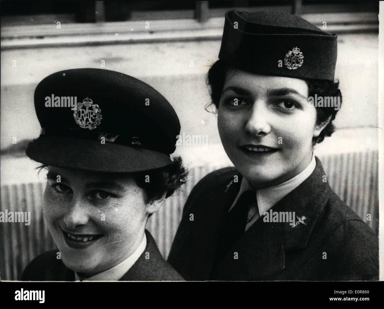 Jul. 07, 1958 - New Hat style for the W.R.A.F.: At the Air Ministry today Aircraft woman display old and the new style hat which is considered to be more becoming to all types of faces. Photo shows Senior Aircraft woman, Margaret Middleton, on left, 21 of Thornton Neath, Surrey, wearing the old-style hat, and 18-year old Gloria Davies, 18, of B, ham, wearing the new style at the Air Ministry today. Stock Photo