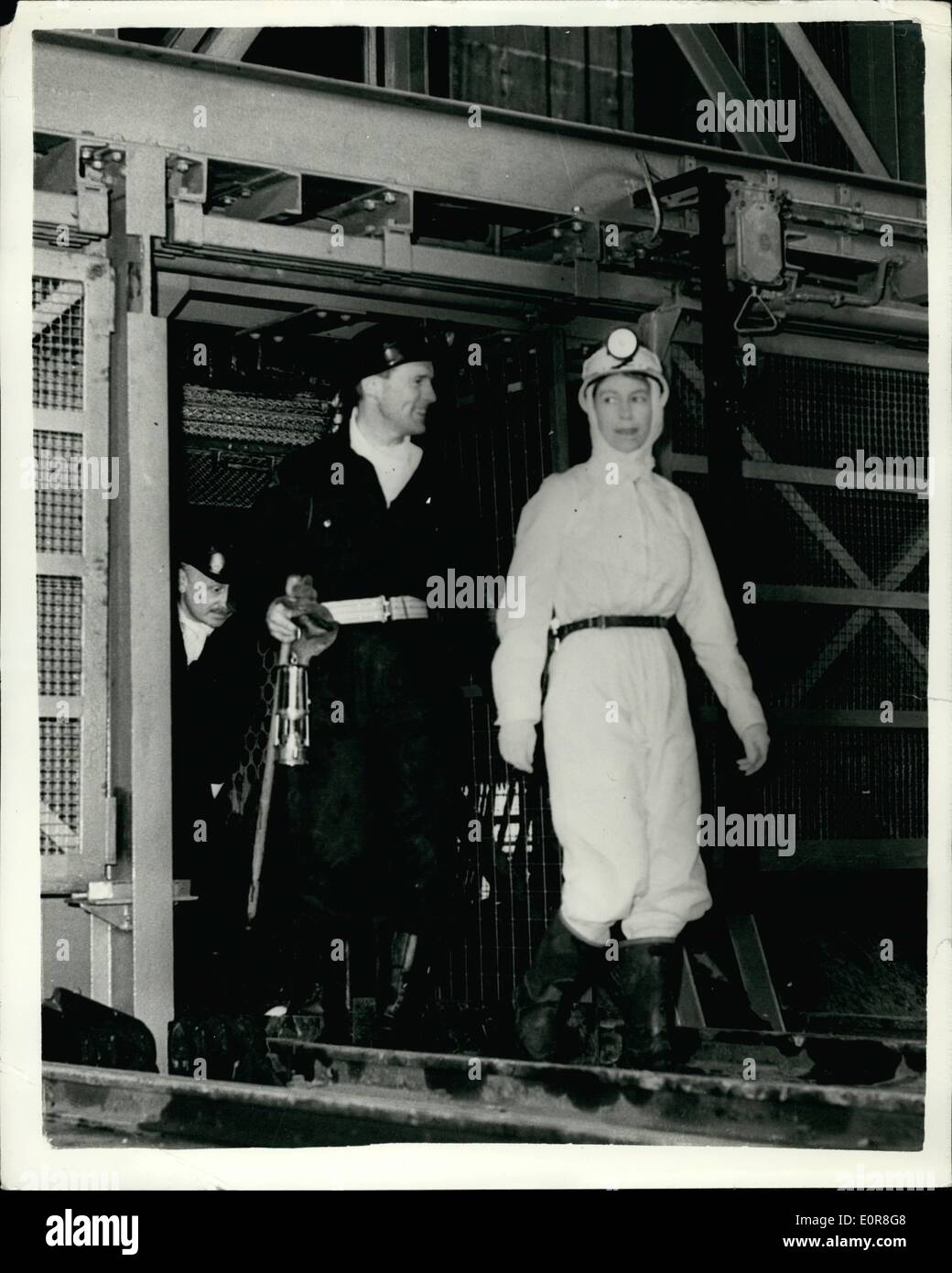 Jul. 07, 1958 - Queen goes down a mine wearing white boiler suit. H.M. The Queen yesterday went down the Rothes pit, near Kirkcaldy, Fifeshire. as part of her tour of Scotland. It was her first descent of a coal mine and she wore a smart white boiler suit, white headscarf and helmet and miner's lamp. Keystone Photo Shows: The Queen seen leaving the cage which brought her up, after going down the mine yesterday. JSS/Keystone Stock Photo
