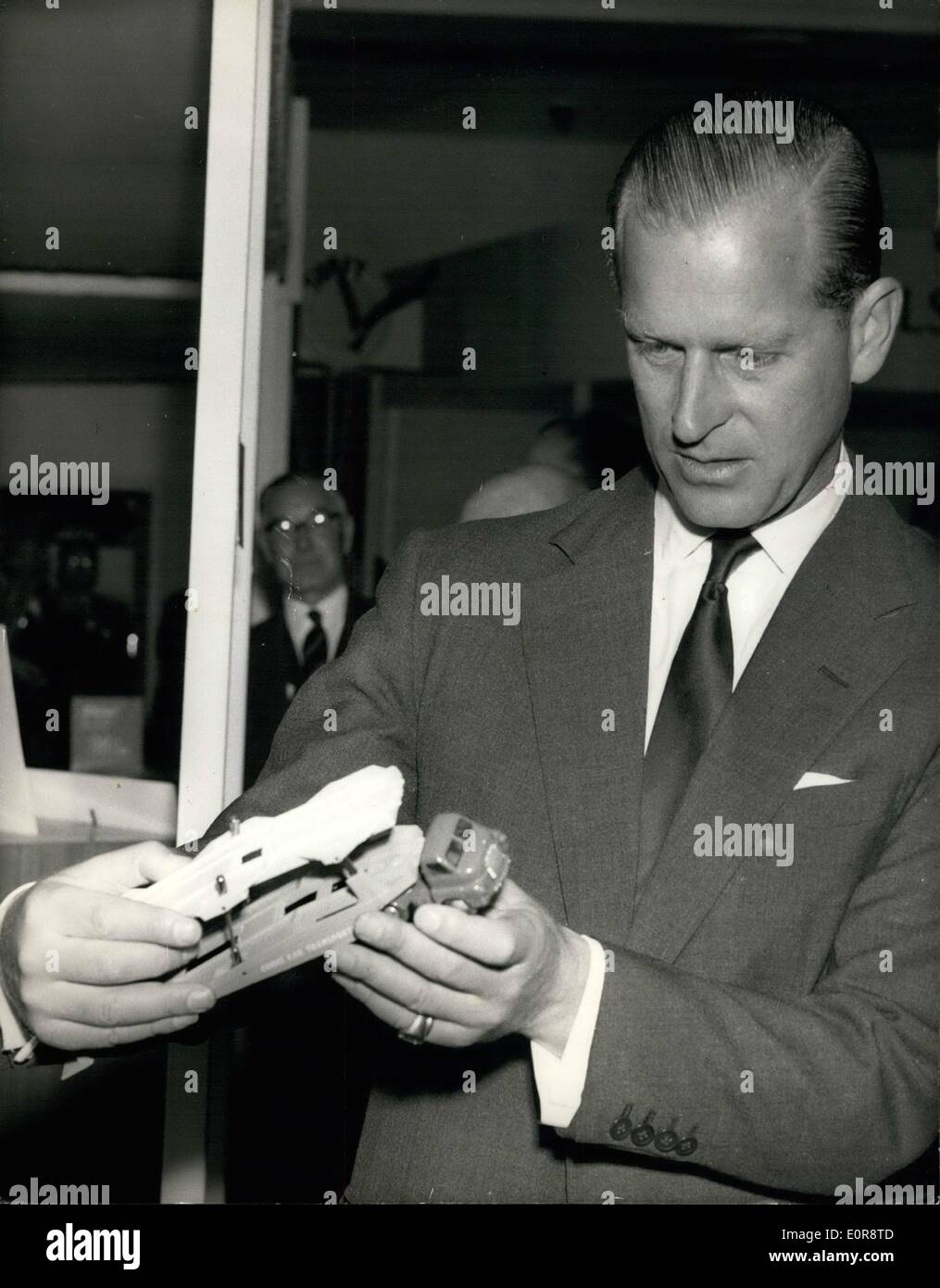 Jul. 07, 1958 - Duke of Edinburgh Opens Exhibition In Cardiff. Photo Shows:- The Duke of Edinburgh examines a toy car transporter during his visit to the James Howell Company Ltd, in Cardiff, Wales, to open an exhibition by the National Union of Manufacturers. Stock Photo
