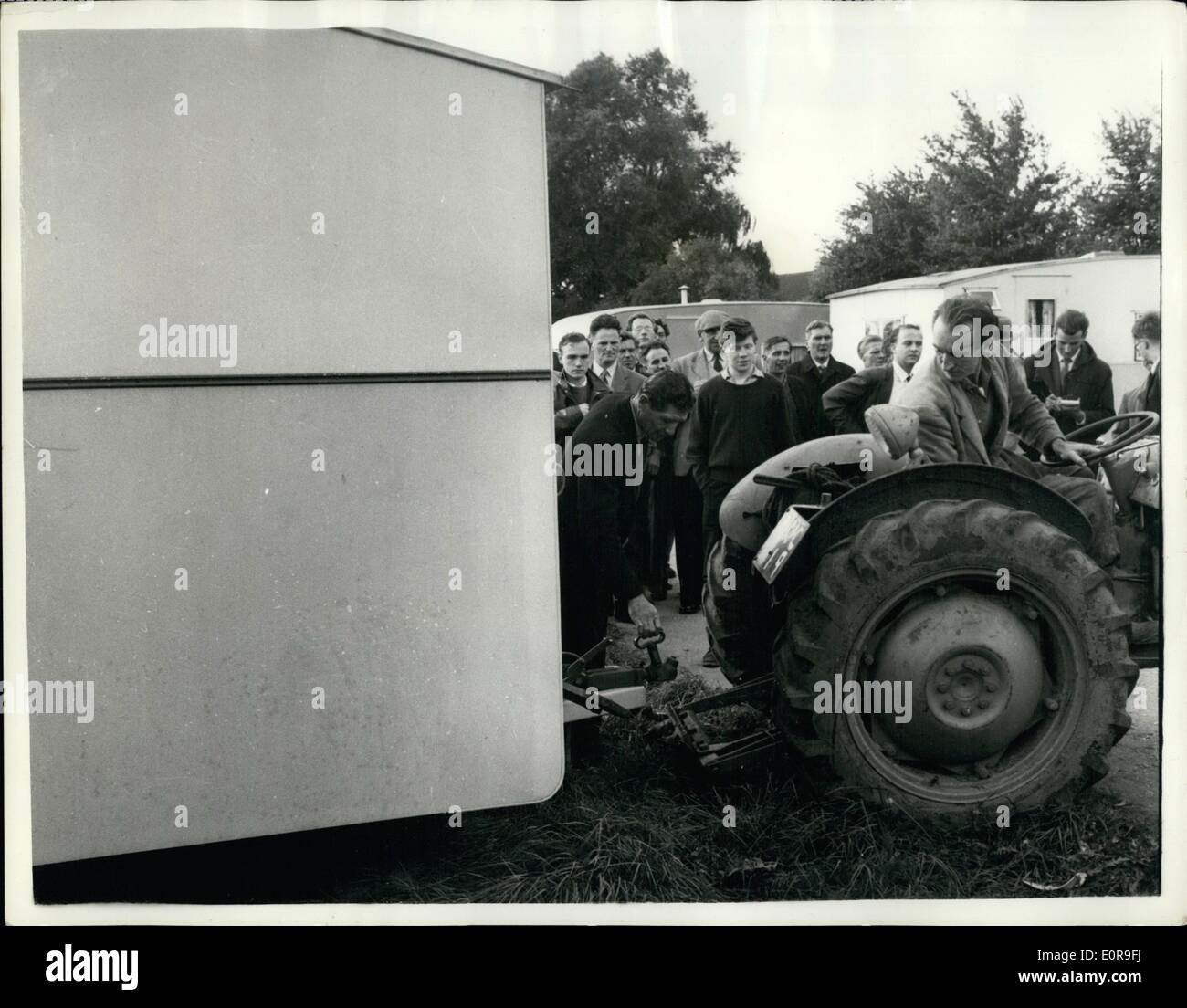 Oct. 10, 1958 - Caravan Eviction force withdraws: Police and bailiffs, who went to the caravan site at Chertsey-lane, Egham, Surrey, yesterday, to enforce a high court order to clear the unlicenced site, were withdrawn on to instruction of Judge P.L.E Rawlings. He adjourned until next Wednesday an application made at Slough Country for a stay of execution. When the bailiffs arrived, woman dragged an old caravan across the entrance to the site. During the next four hours the bailiffs brought in two tractors, a lorry and a land rover to tow the caravans away Stock Photo
