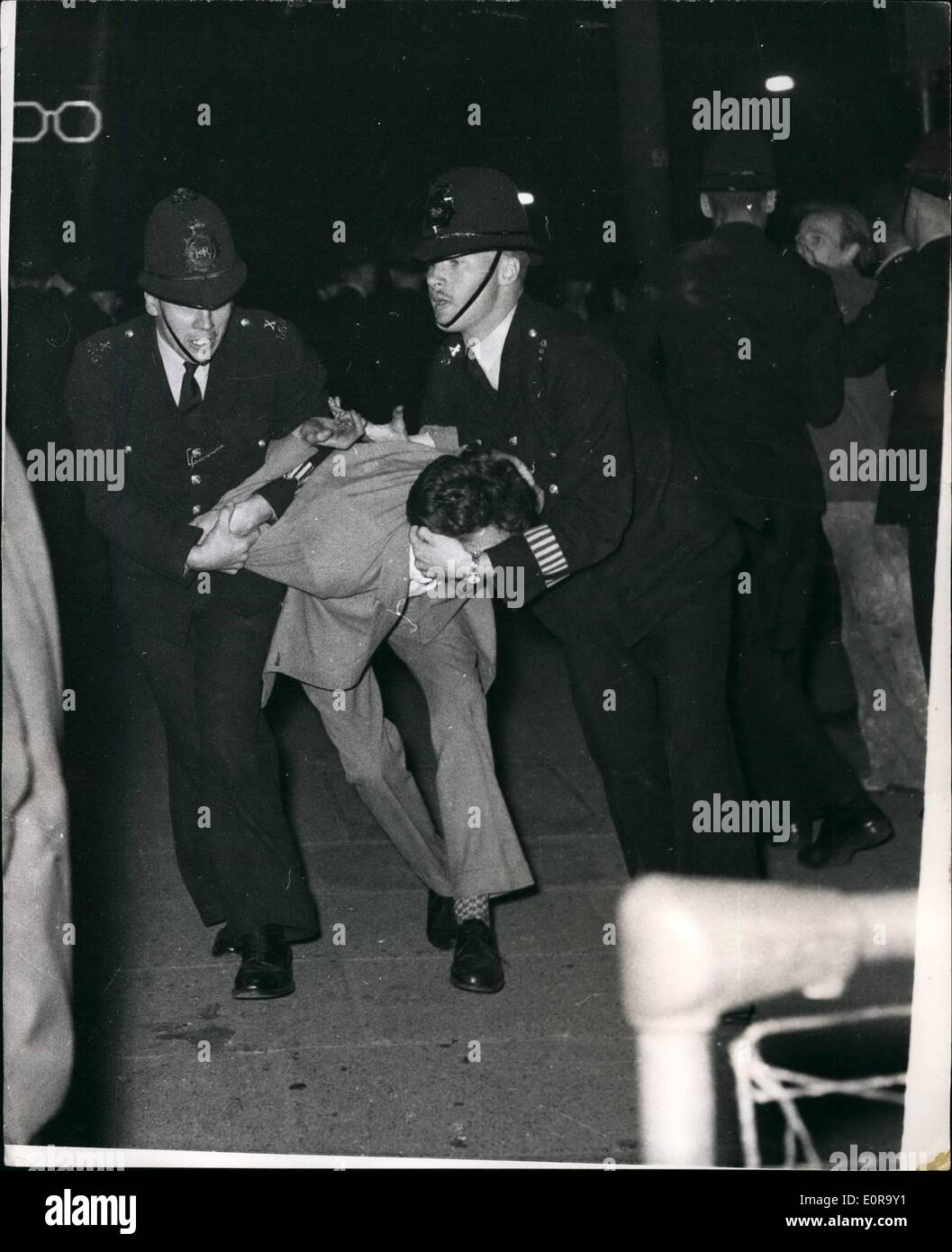 Sep. 09, 1958 - Black-White Racial Riots Once Again In Notting Hill Gate.. Police Struggle With A Demonstrator. Many arrests were made in the Black - White racial riots which broke out again for the fourth night in succession at the Notting Hill Gate area of London. Keystone Photo Shows:- Policeman struggle with rioter - in Blenheim Crescent... Many arrests were made. Stock Photo