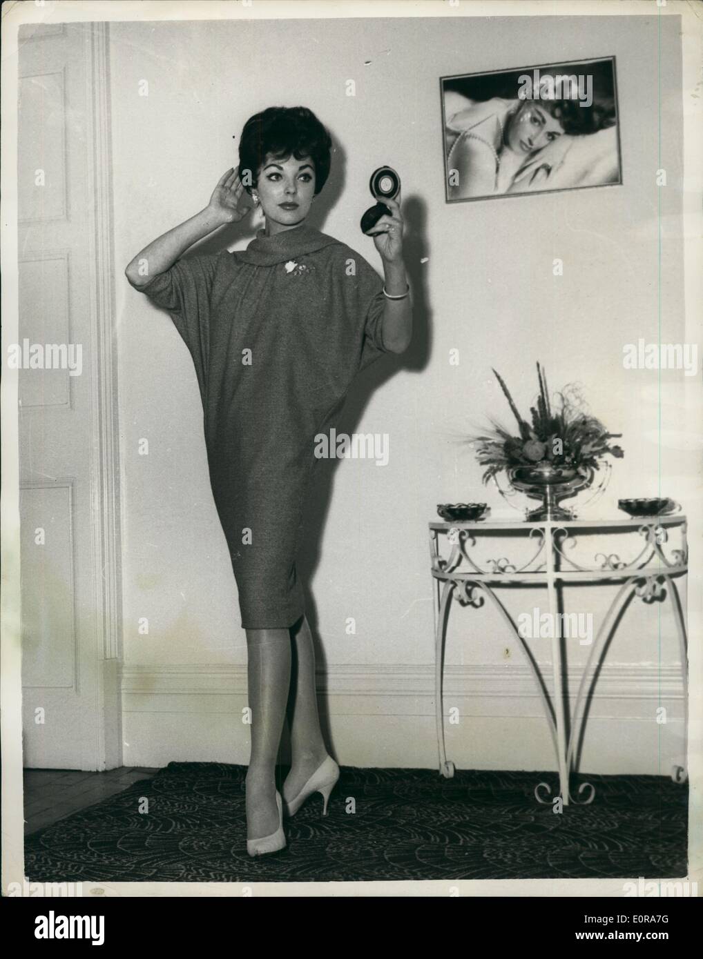 Nov. 11, 1958 - Joan Collins Flies To London. Photo shows British film star Joan Collins wears a red sack dress - in London night. She arrived a few hours earlier for a five day visit to her parents before returning to Hollywood. Stock Photo