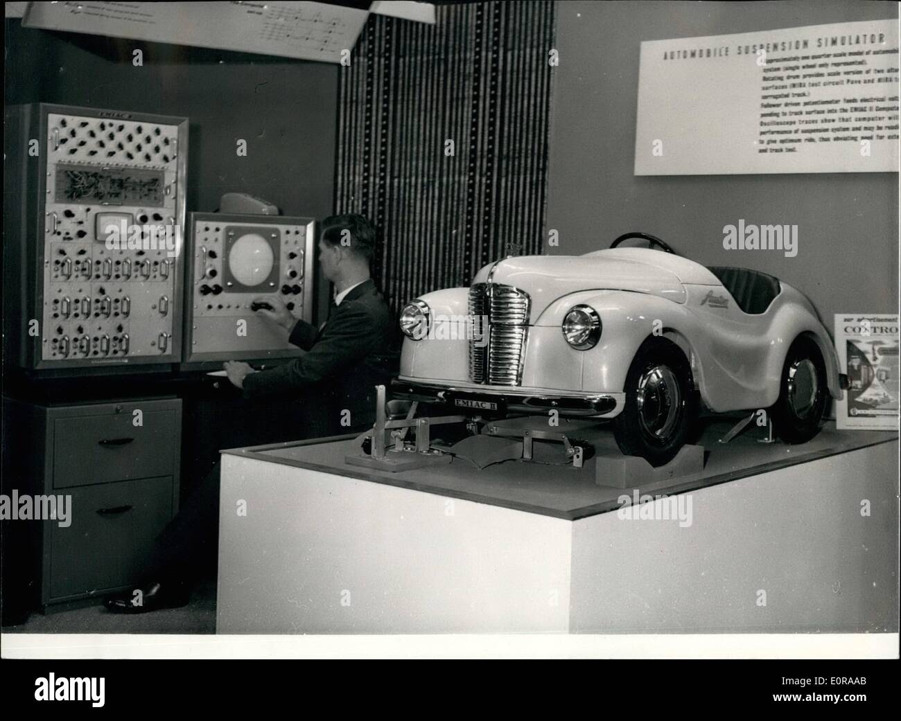 Nov. 11, 1958 - Lord Mayor Opens Electronic Computer Exhibition: The Lord Mayor of London Sir Harold Gillett this morning opened the Electronic Computer Exhibition at Olympia. Photo shows An operator at the panel - controls the Automobile Suspension Simulator - on a model - at the exhibition. The quarter scale model shows how E.M.I.A.C.II Computer can be used to test car suspension system under varying road conditions. Stock Photo