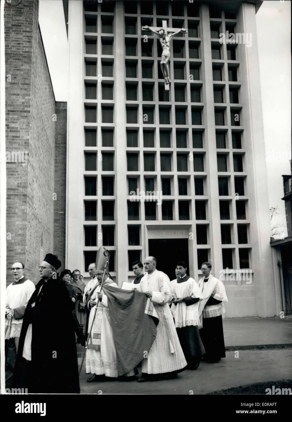 Nov. 11, 1958 - New Roman Catholic Church Consecrated: The New Roman Catholic Church of the Perpetual Aderation, Beaufort Street, Chelsea - was consecrated this morning Bishop David Cashman the Auxiliary of Westminster. Photo shows The procession which includes Bishop Cashman - leaving the Church beneath the aluminium crucifix - during the service this morning. The Crucifix is 10ft. high - but only weigh 40 lbs. Stock Photo