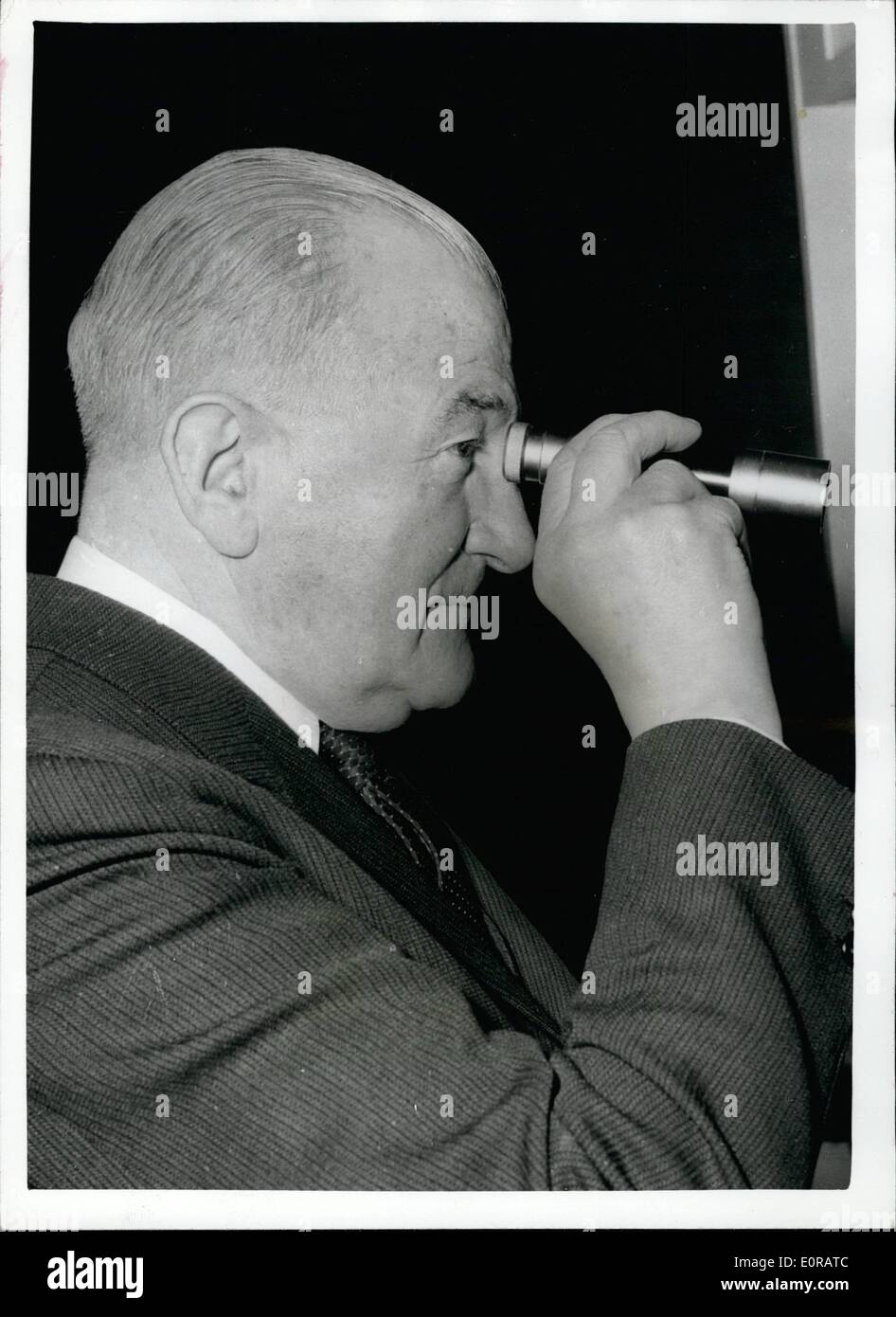 Nov. 11, 1958 - Lord Mills Opens ''clear the Air'' Exhibition Lord Mills, minister of Power today opened the Roayl Society of Health's Exhibition on ''Clean Air'' at the Society Headquarters in Buckingham Palace Road. Lord Mills seen looking through a ''Telesmoke''-an instrument for measuring smoke by smoke abatement officers-at the ''Clean Air' Exhibition today. Stock Photo