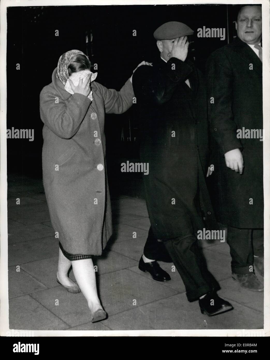 Dec. 12, 1958 - Barbara Baker - the Dog-Case Girl Plays 0 Penalty: Barbara Baker the 24 year old kennel girl who was the missing witness in the dog doping trial at the Old Bailey - went to Cannon Row Police station yesterday. She left after six hours - after paying 0 - the amount in which she was bound over at a magistrate's court to appear at the trial., Photo Shows Barbara Baker - and her father hide their faces - after visiting Nannon Row Police station. Stock Photo