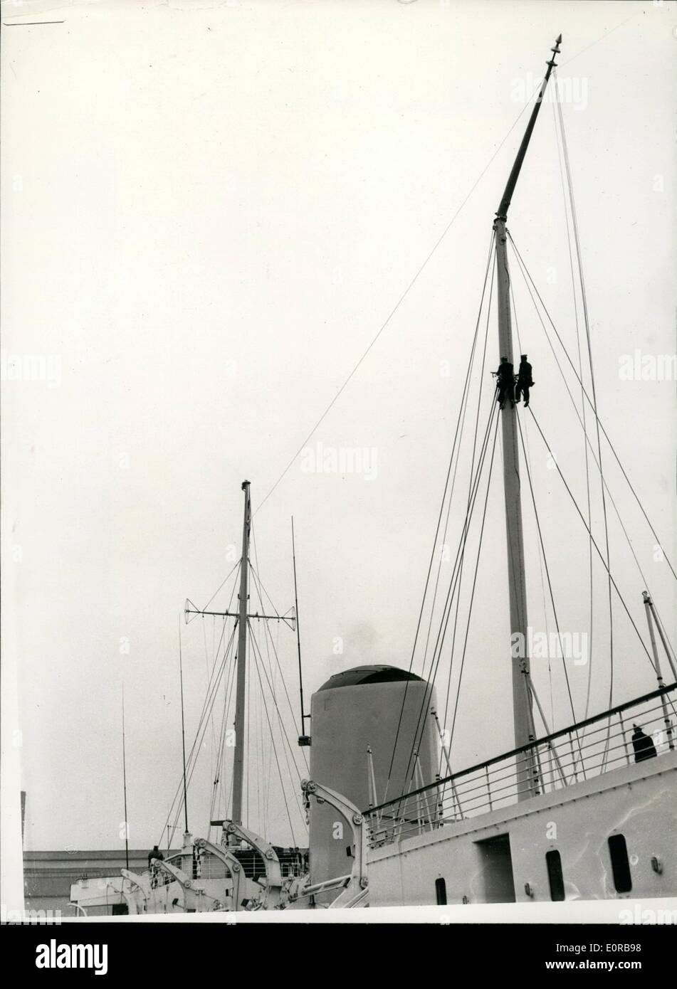 Nov. 11, 1958 - Masts of H.M. Yacht Britannia hunged in readiness for visit to Canada.: To allow H.M. Yacht Britannia to pass under the bridges of the St. Lawrence Seaway - during the Royal Visit to Canada next year the tops of her foremast and mainmast (118ft. and 123 ft. high res.) have been hinged in order that they can be lowered when necessary. The hinged masts were demonstrated at Portsmouth this morning. Photo shows two members of the crew - A/B Stock Photo