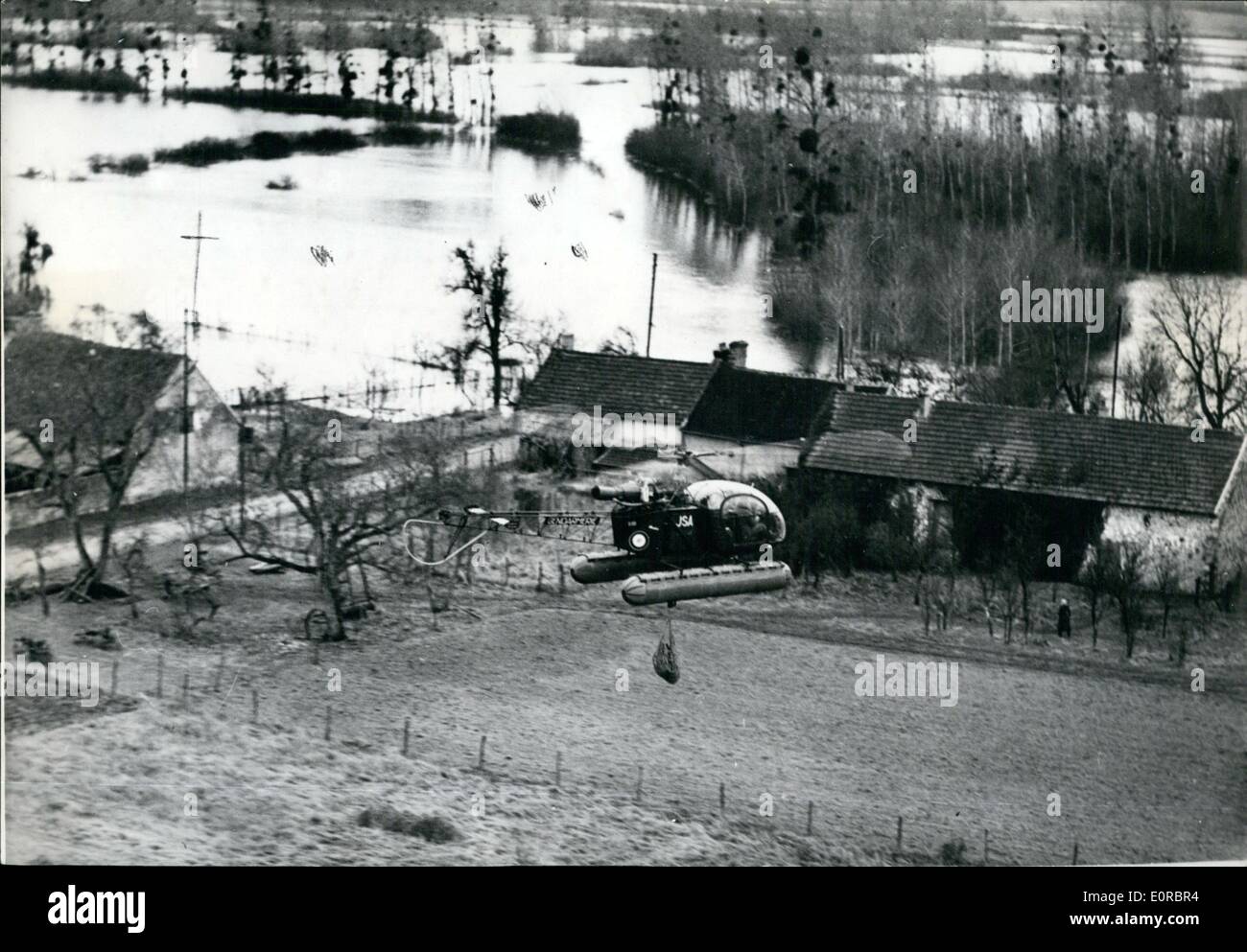 Jan. 01, 1959 - Copter brings food to victims of floods: At Bray Seine, in the flooded area of Montereau, police helicopters are supplying food to flooded farms. Photo shows helicopter lowering mail and food to flooded farms. Stock Photo