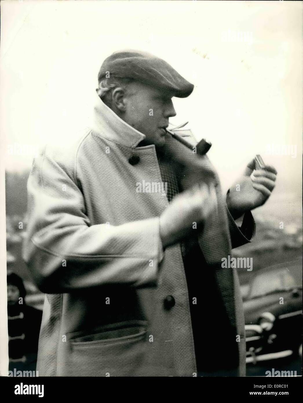 Dec. 12, 1958 - MIKE HAWTHORN AT BRAND'S HATCH Mike Hawthorn, the world champion motor racing driver, who recently announced his retirement from the circuits, went along to Brand's Hatch yesterday, where he acted as starter in the main event, the Silver City trophy race. PHOTO SHOWS:- MIKE HAWTHORN pictured as he lights his pipe - at Brand's Hatch yesterday. Stock Photo
