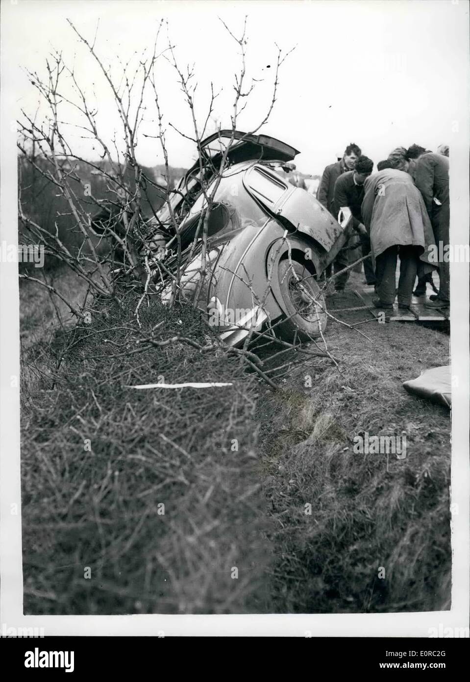 Jan. 01, 1959 - MIKE HAWTHORN KILLED AS HIS CAR HITS A TREE ON GUILDFORD BY-PASS MIKE HAWTHORN, Britain's champion racing driver who flirted with death hundreds of times on racing circuits, died today in a car crash at Guildford, Surrey. His black Jaguar was in collision with a lorry on the Guildford By-pass. It double-somersaulted, then smash against a tree, killing Mike Hawthorn outright. The death of the 29-year-old champion came only a month after he had retired from motor racing while he was the holder of the sport's greatest honour Stock Photo