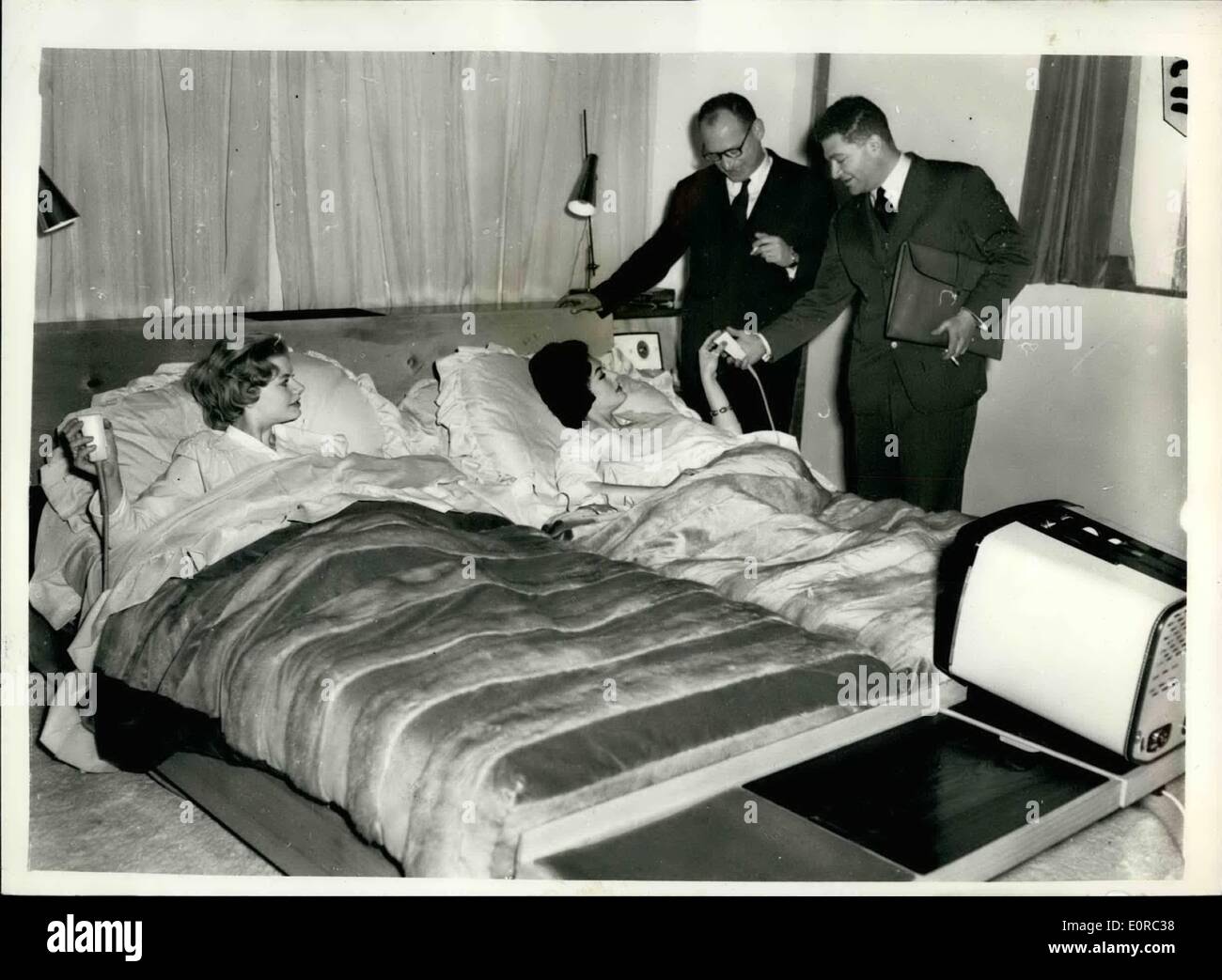 Jan. 01, 1959 - Private View Of Furniture Exhibition. Frenchmen Buys 2500 Bed. ''The Bed'' - Slumberland's 2,500 creation, which is one the major attractions of the furniture exhibition, which opens on January 28th at Earl's Court, was baught today by representatives of galeries barbes, of Pairs, specialists in furniture and tapestries. With it's remote control panels and twin springwall mattresses that are individually adjustable and heated, The Bed heralds a new ''era of the bedroom''. Photo Shows: M. Henri Gross, chairman of galeries barbes, of Pairs, and M.R.D Stock Photo