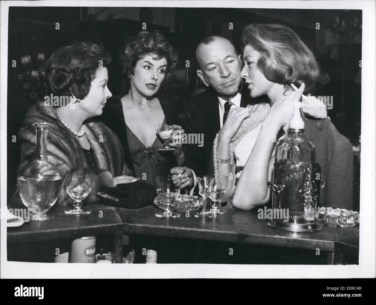 Jan. 01, 1959 - The lucky Squire of London town Noel Coward escorts three fascinating women: Mr. Noel Coward was surely the luckiest man in London last night, when, bearing like a benevolent sultan he escorted three of the world's most fascinatiing women, Kay Kendall, Vivian Leigh and Lauren Bacall, to the St Martin;s Theatre. They went to see ''The grass is greener'' starring their mutual friend, Celia Johnson. The party had been laid on by Vivian Leigh Stock Photo