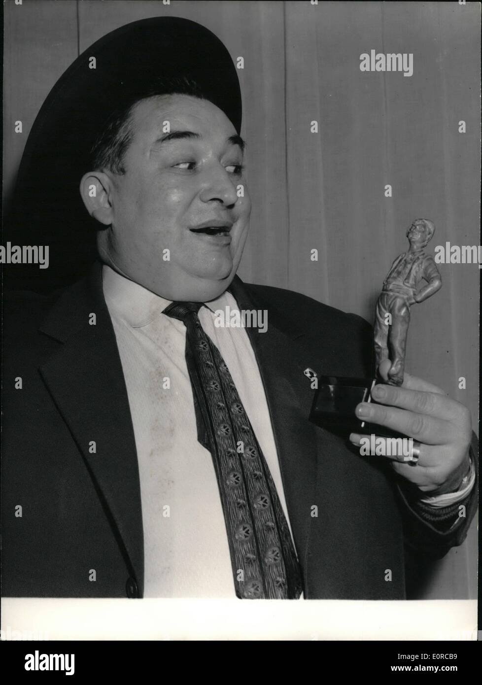 Jan. 01, 1959 - Paris Pedlar gets award for humor: A distribution of awards to the best Pris street Pedlars was held at the coupole, the famous Montparnasse cafe and brasserie, this morning. Photo shows Max Dupuy (Alias ''max the necktie'') the well-known a reet pedlar who sells neckties on the boulevards showing his award, an ''Oscar'' for the most humorous demonstration' Stock Photo