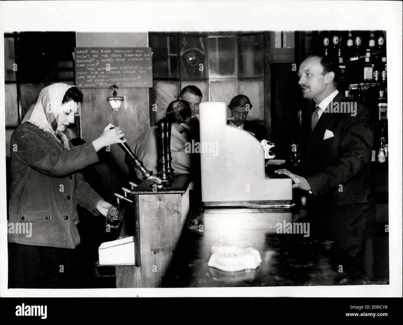 Jan. 19, 1959 - London's First ''Serve-Yourself'' Public House.: The first self-service public house installation has been introduced at the Elephant and Castle Public House, Kensington - London. The Pub is run by ex Cavalry man Charles Farrow - and he has fixed up three pumps in the lounge bar - on the costomers' side - and beer drinkers can pull-their - own-pints. Charles says that the idea is profitable- The customer pays for the beer and receives a glass and then help themselves Stock Photo