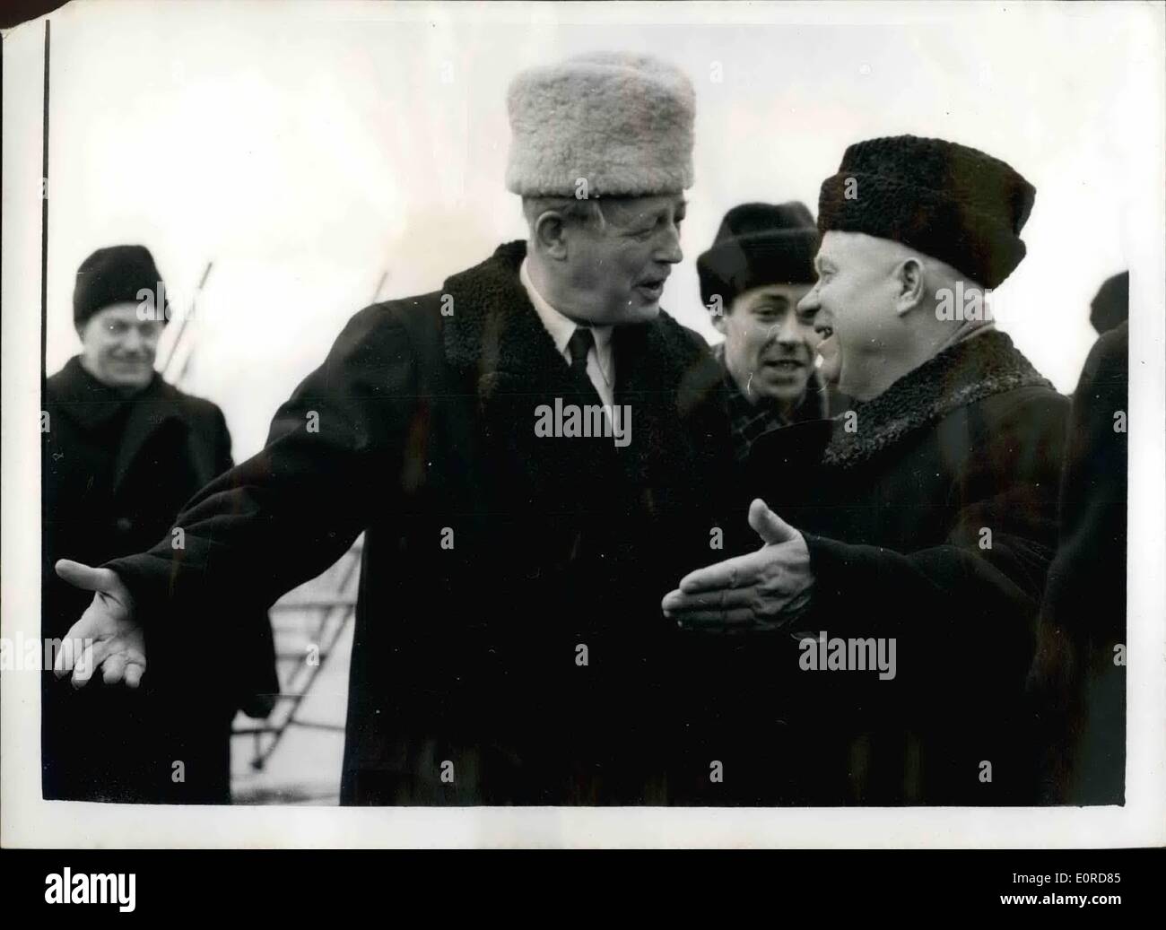 Feb. 02, 1959 - Mr. Macmillan Visits Moscow. Photo shows A smiling Mr. Kruschev, with outstretched hand, greets the British Prime Minister, Mr. Harold Macmillan, when the letter arrived in Moscow after his flight from London. Mr. Macmillan wore a striking white furry hat. Stock Photo