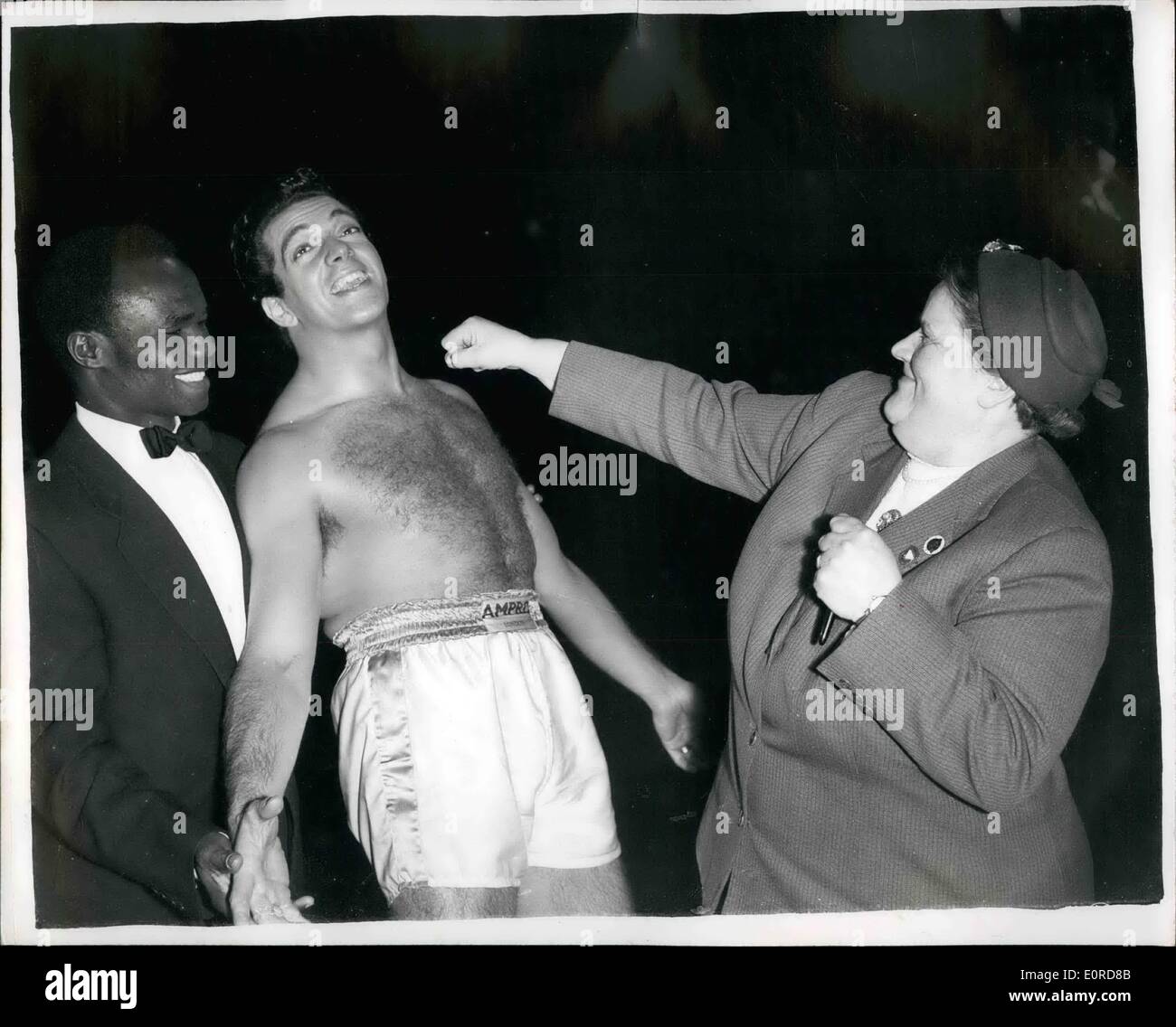 Feb. 02, 1959 - Frankie Vaughan in the ring at Pinewood. One of the most unusual sequences over shot at Pinewood, was filmed today for the Anna Neagle production for the Rank Organisation, ''The Heart of a Man'', which stars Frankie Vaughan, Anne Heywood and Tony Britton. The sequence was a full-scale Variety Club of Great Britain Charity Boxing Tournament , in which Frankie went several rounds with Pinewood's fight expert, Rupert Evans. The referee was world featherweight champion, Hogan 'Kid' Bassey. Photo Shows Mrs. Bessie Braddock, M.P Stock Photo