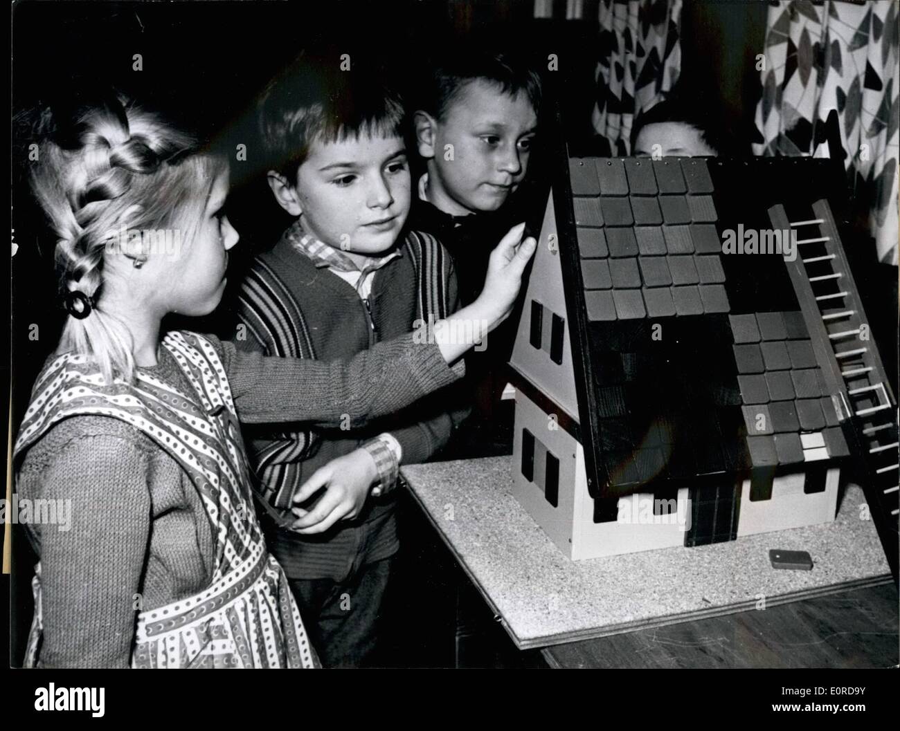 Feb. 02, 1959 - Children learn the 'witch multiplication table'.: The children of the elementary-schools in Nuremberg will learn the 'witch-multiplication-table' in short time. The instruction median is the 'witch-house' an invention of the school inspector Alfred Angermeyer from Neustadt who already ordered to produce a whole mass of the little 'witch-houses'. The witch house is nearly well known to all children by the tale 'Hansel and Gretel'. It can be taken apart nearly into all detail and that is already the moment where the arithmetic lesson begins Stock Photo