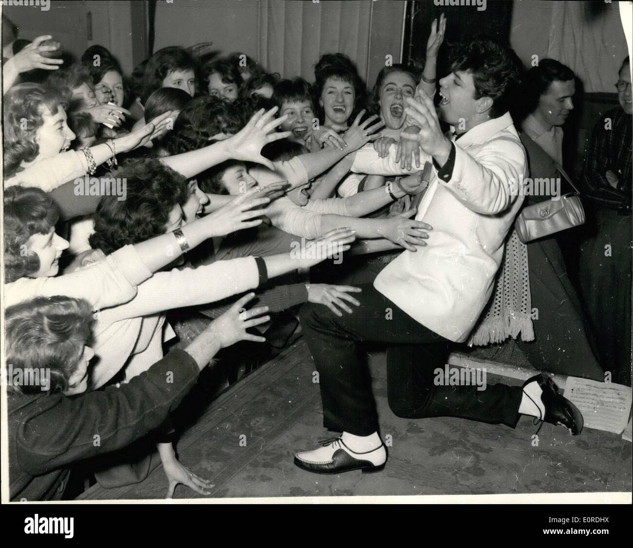 Feb. 02, 1959 - Cliff Richards ''sends'' 'em... Rock 'n Roller Cliff Richards last night invited 100 fans to watch him cut his first long play disc at a London recording studio. Cliff Richards is 18 years of age and earns 00 a week. Keystone Photo Shows: Cliff Richards as some of his fans are ''sent'' at the studio. Stock Photo