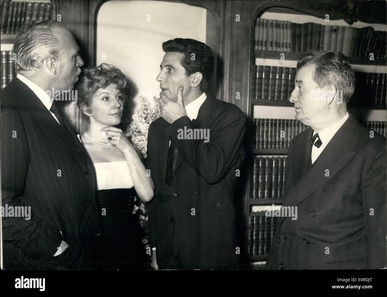 Feb. 02, 1959 - American Film Producer Plans Re-mark on Pagnol's Famous Trilogy: Joshua Logan, the famous American Fil Producer, is now in Paris to make arrangements for a re-make of Marcel Pagnol's famous trilogy ''Marius'', ''Emmy'' and ''Cesar''. Gilbert Becaud, the successful French Singer-composer and actor, has been proposed the Pagnol to play the role of Marius. Photo Shows Marcel Pagnol (right) introducing Gilbert Becaud (center) to Joshua Logan during the American Producer's visit to Pagbol's Paris home Stock Photo