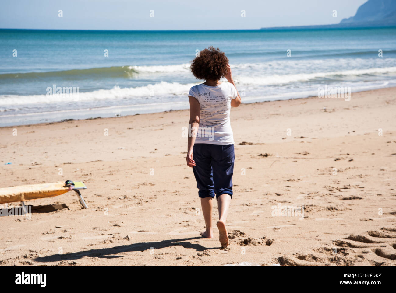 Lone woman running on beach hi-res stock photography and images - Alamy
