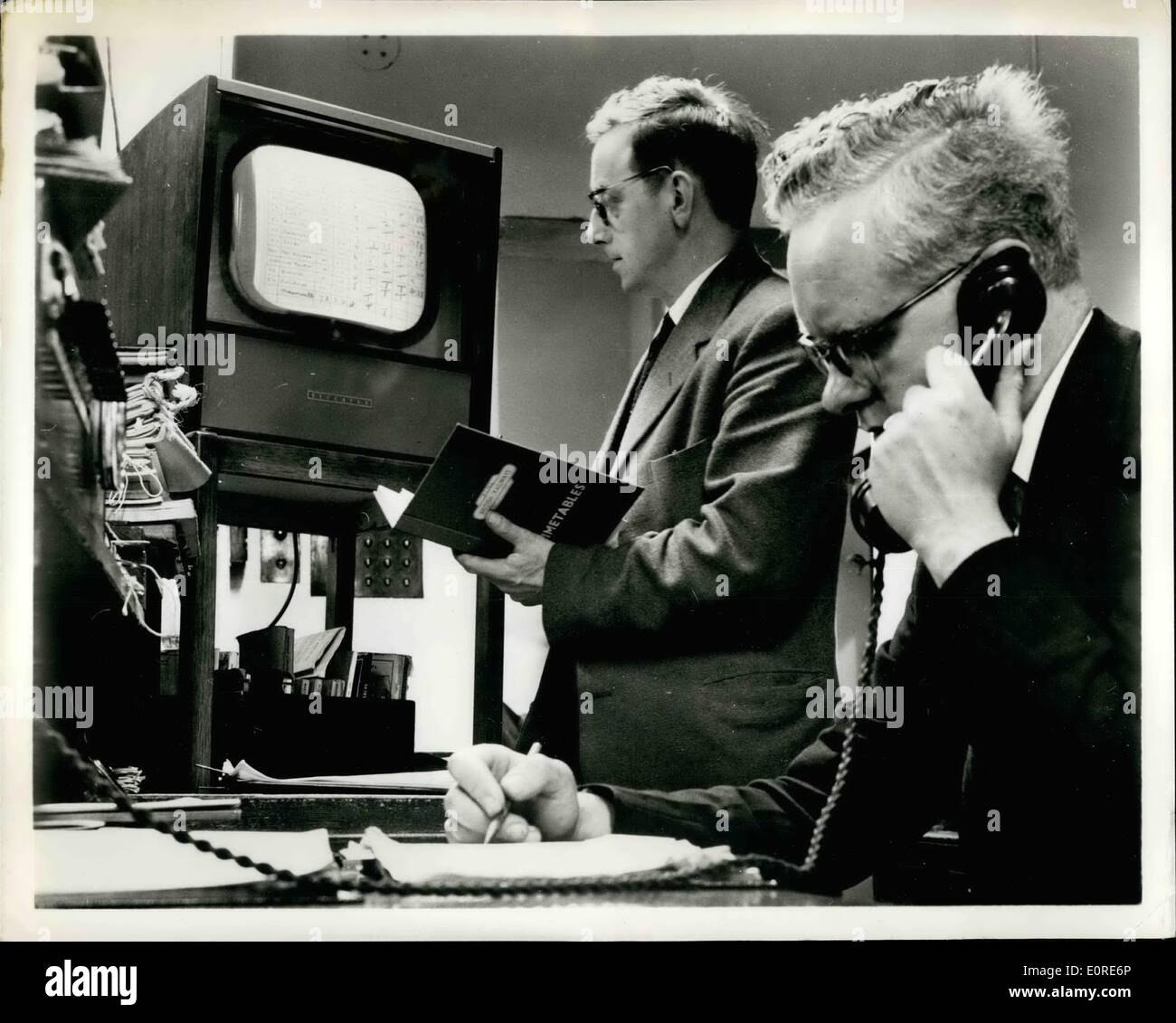 Apr. 04, 1959 - TV ON THE TRACK: British Railways are using closed-circuit television to provide key rail road men with information on the running of main line trains into King's Cross Station, London, and to speed-up information to the public. Known as Deccafex, the system is also in use in a U.S Army Air Force Station in Britain, in a British stock-broker's office and on a racetrack in South Africa. Picture shows:- Receiving unit in the inquiry office at King's Cross Station lists information about trains. Stock Photo