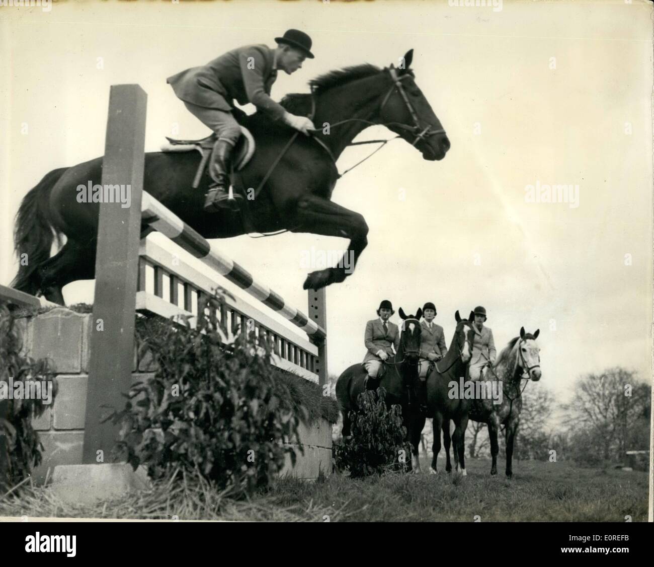 Apr. 04, 1959 - Course for show Jumpers at Arundel Castle: A fortnight's course for our leading Show-Jumping riders, is being held at Arundel Castle, by permission of the Duke and Duchess of Norfolk. The organisation of the course is undertaken by Lt. Col. N.H. Kindersley, and tuition is given by Lt. Col. J.A. Talbot - Ponsonby, the Olympic coach. Picture Shows: Three Young members watch another take a jump during the course at Arundel. The lady members are (L ti R): Mrs. Stewart Banks, of Nafferton, nr. Driffield, Yorkshire; Miss Mary Barnes, of Bentworth, nr Stock Photo