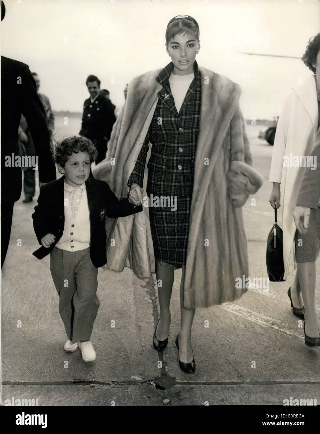 Apr. 04, 1959 - Pier Angeli brigs her son to London defiance of America court order. Actress Pier Angeli arrived at London Airport this afternoon with her son Perry. She is aid to have brought the boy to London from America in defiance of an emergency court order restraining her from taking him out of the United States because of divorce proceedings between Pier and husband singer Vic Damone .Photo shoes Pier Angeli and her son Perry walking from the aircraft at London airport this afternoon. Stock Photo