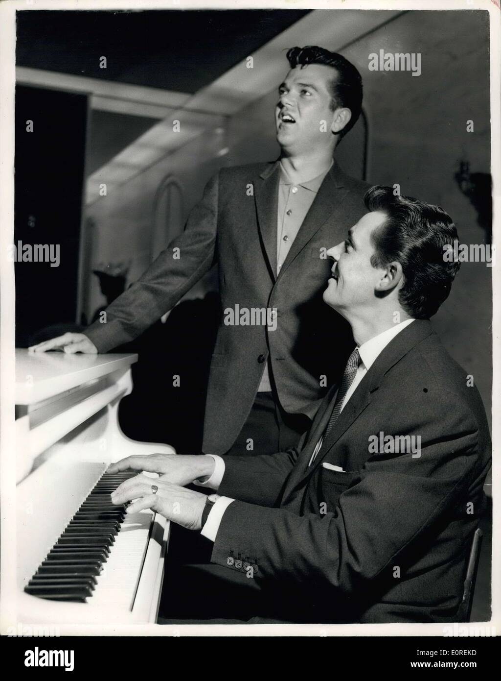 May 15, 1959 - Russ Conway - and Conway Twitty get together: Russ Conway the popular British pianist - and Conway Twitty the American singers were to be seen together at the Savoy Hotel this morning. Russ Conway is appearing on the B.B.C Billy Cotton TV show - while Conway Twitty is appearing on the rival channel in ''OH-Boy'' - but both stars record for the same company E.M.I. which includes H.M.V and Colombia records. Photo shows Russ Conway accompanies Conway Twitty on the piano - when they met at the Savoy Hotel this morning. Stock Photo
