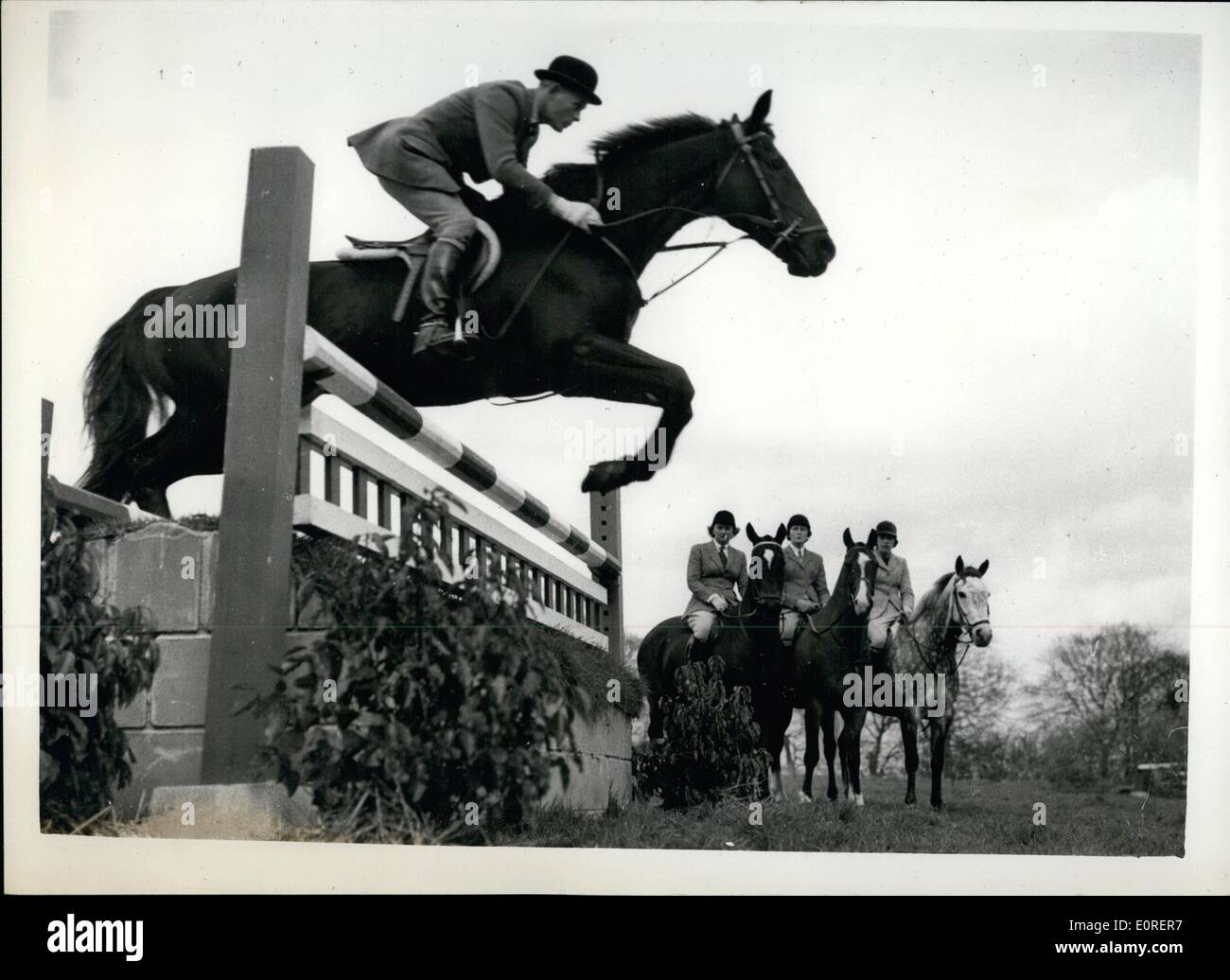 Apr. 08, 1959 - 8-4-59 Course for show jumpers at Arundel Castle. A fortnight's course for our leading show-jumping riders, is being held at Arundel Castle, by permission of the Duke and Duchess of Norfolk. The organization of the course is undertaken by Lt. Col. N.H. Kindersley and tuition is given by Lt. Col. J.A. Talbot-Ponsonby, the Olympic coach. Keystone Photo Shows: Three young members watch another take a jump during the course at Arundel Castle. The lady members are (L to R): Mrs. Stewart Banks, of Nafferton, nr. Driffield, Yorkshire; Miss Mary Barnes, of Benworth, nr Stock Photo