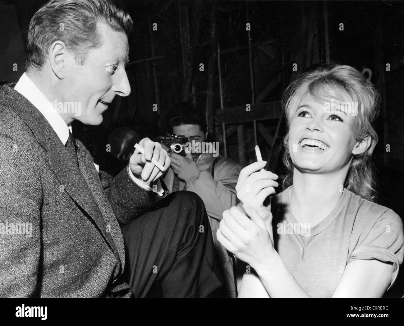 Actress Brigitte Bardot laughing with actor Danny Kaye in a Paris film studio Stock Photo