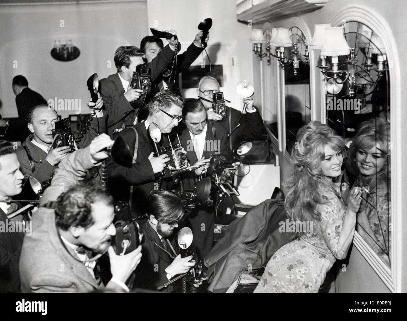 Actress Brigitte Bardot posing for reporters and photographers Stock Photo