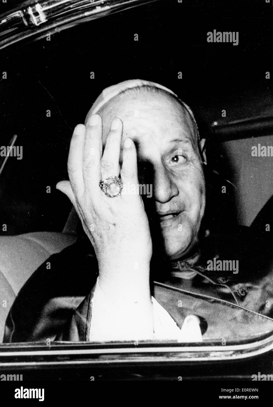 Pope John XXIII covering his face while in a car Stock Photo