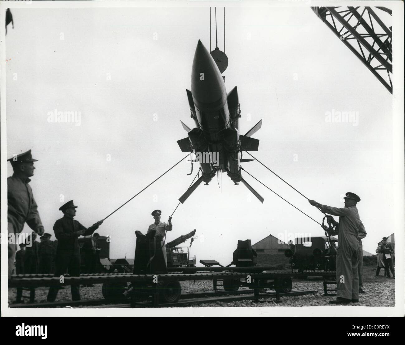 Jun. 06, 1959 - ''Thunderbird'' at surface to air weapon system demonstration: Troops were to be seen operating but not actually firing the Thunderbird, a medium to high altitude surface to air guided weapon system, which has been developed for the Field Army, at a demonstration of Surface to air weapon systems, at the school of Anti aircraft artillery, Manorbier, 5th, Wales. Photo Show The ''Thunderbird'' hanging high from a crane and steadlied by troops with ropes, is loaded on to a launcher loader, after being assembled and tested, at Manobier, 8th, Wales. Stock Photo