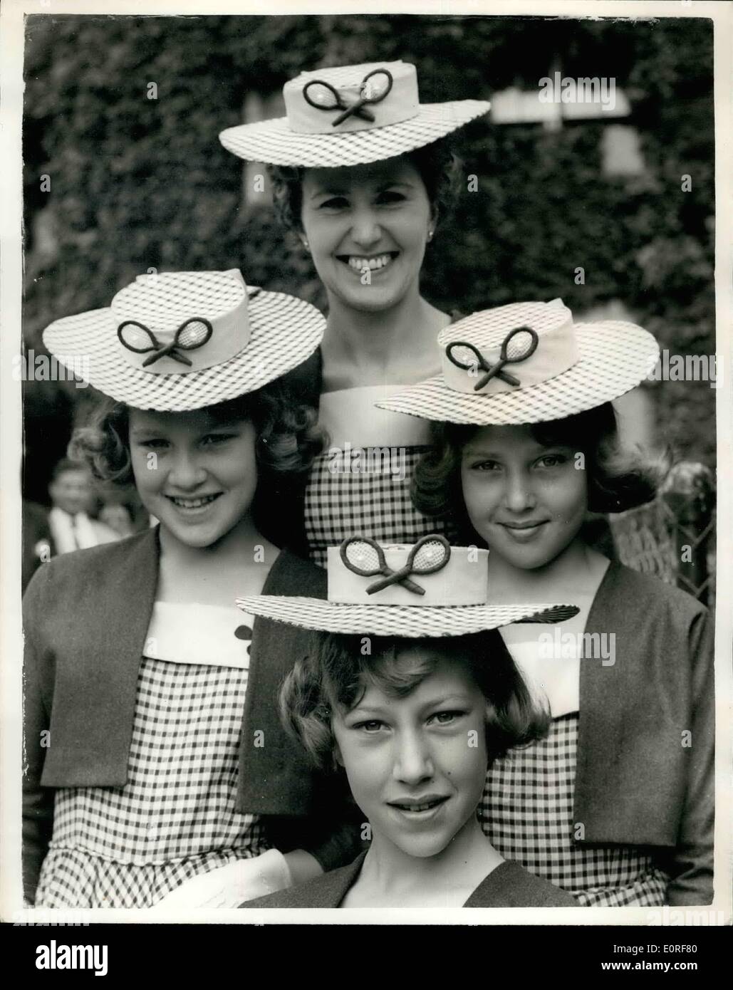 Jun. 06, 1959 - Wimbledon - Second Day: Hats - and Suits - All Alike: Photo Shows Mrs. Jean Carpenter of the Shipton-under-Wyohwood, Oxford - with her daughters - Twins in centre - Wendy - left and Jane aged 12 - and at bottom Susan (13) - arriving for second day of Wimbledon today. They all wear matching boater hats and identical suits - all made by mother. Stock Photo